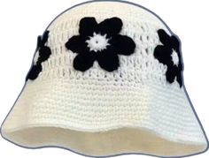 a white hat with black flowers on it