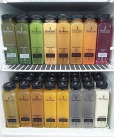 a refrigerator filled with lots of different types of juice