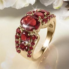 A sophisticated, yet understated piece. Finely crafted from sterling silver, finished in 18k luxurious yellow gold. A fiery oval cut Garnet has been handset into the heart of this chic design. The center stone is flanked with even more Garnet stones to create an elegant piece that is both easy to wear every day and on special occasions. Luxury Ruby Ring With Gemstone Accents For Anniversary, Exquisite Ruby Ring With Gemstone Accents For Anniversary, Luxury Gold Ruby Ring With Accent Stones, Gold Ruby Ring With Gemstone Accents For Anniversary, Elegant Birthstone Ring With Gemstone Accents, Luxury Ruby Ring With Stone Setting For Formal Events, Luxury Ruby Ring With Stone Setting For Formal Occasions, Gold Oval Birthstone Ring With Gemstone Accents, Luxury Formal Ruby Ring With Stone Setting