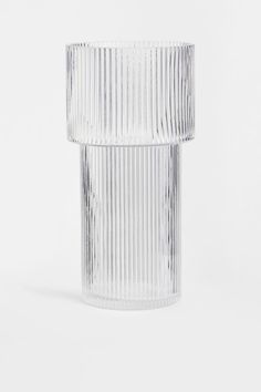 a clear glass vase sitting on top of a white table