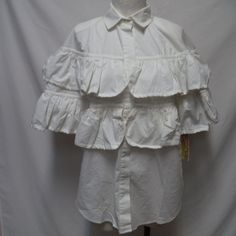 Brand New Size Medium, 100% Cotton. Measures 24.5" From Underarm To Underarm, 27" From Shoulder To Hemline. Thank You. Chic Ruffled Button-up Top, Spring Blouse With Ruffled Collar And Buttons, White Collared Shirt With Ruffles, Cotton Button-up Tops With Ruffles, Daywear Short Sleeve Blouse With Ruffles, Cotton Ruffle Button-up Tops, Cotton Ruffled Button-up Tops, Short Sleeve Ruffled Blouse For Daywear, Spring Top With Button Closure And Ruffled Collar