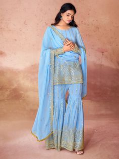 This gorgeous set includes a sky-blue color georgette suit with intricate embroidery and sequin work, a matching georgette sharara with the same delicate detailing, and a dupatta adorned with embroidered sequin work, and designer lace work. The sharara suit comes fully stitched and is available in XS to XXL sizes, ensuring a perfect fit for everyone.
This sky-blue sharara suit is endless. Not only does it offer a stunning and unique look, but you can also wear it to festivals, functions, and eve Blue Georgette Sharara With Gota Work, Bollywood Style Light Blue Sharara, Blue Georgette Palazzo Set With Mirror Work, Blue Georgette Palazzo Set For Eid, Traditional Light Blue Palazzo Set With Dupatta, Blue Chinon Palazzo Set For Diwali, Diwali Blue Chinon Palazzo Set, Blue Georgette Sharara For Diwali, Blue Sharara With Gota Work In Chinon