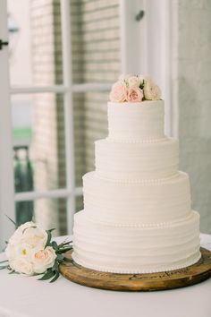 a white wedding cake sitting on top of a table