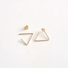 A simple and unique earring that is sure to get noticed when you want it! The open triangle measures 15mm per side and is made with solid sterling silver, 14k gold filled, and 14k rose gold filled. These are all great options if you have sensitive ears! <> The Open Triangle Measures 15mm per side <> Materials - .925 Sterling Silver, 14k Gold-Filled, & 14k Rose Gold-Filled <> Ear nuts come with either sterling silver, 14k gold fill, or 14k rose gold fill <> Posts measu Minimalist Sterling Silver Tarnish Resistant Threader Earrings, Minimalist Sterling Silver Tarnish-resistant Threader Earrings, Minimalist Tarnish-resistant Sterling Silver Threader Earrings, Modern Threader Earrings As A Gift, Minimalist Triangle Hoop Earrings As Gift, Minimalist Triangle Jewelry For Pierced Ears, Minimalist Rose Gold Threader Earrings, Minimalist Triangle Jewelry, Minimalist Pierced Threader Earrings As Gift