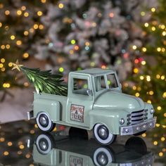 a toy truck with a christmas tree on the back