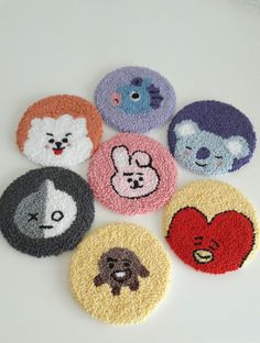 six coasters with animals on them are arranged in the shape of hearts and faces