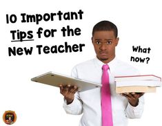 a man with a pink tie is holding a book