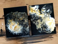 two black and white paintings on wood with one being painted yellow, the other is made out of acrylic paint