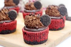 several red velvet cupcakes with chocolate frosting and oreo cookies on top