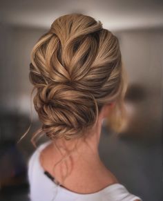 a woman with blonde hair in a low bun