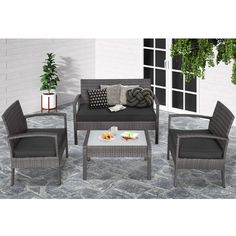 an outdoor patio furniture set with cushions and coffee table