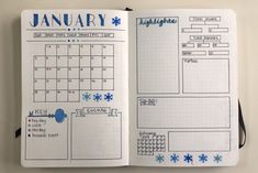 an open planner book with blue snowflakes on the pages and writing in it