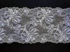 an image of a white lace with flowers on it's side and black background