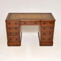 an antique wooden desk with drawers on it