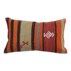 an orange and brown striped pillow on a white background