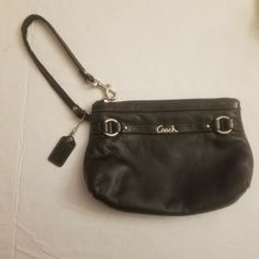 Coach Gallery Black Leather Medium Corner Zip Wristlet with Wrist Strap, Hangtag Coach Good Used Condition Black Leather Corner Zip Wristlet Gallery Medium Wristlet Approximate Measurements Height 5" Length 7" This Coach Gallery Black Leather Medium Wristlet is in good used condition, the wrist strap has some wear as noted in photos. This medium sized wristlet is made of soft black leather and has a corner zip closure. It is from the Coach gallery collection and it has silver tone hardware.  It Coach Leather Wristlet With Zipper Closure, Black Leather Wristlet, Formal Leather Wristlet, Formal Leather Wristlet With Wrist Strap, Leather Wristlet With Wrist Strap For Formal Occasions, Leather Formal Wristlet With Wrist Strap, Coach Wristlet With Wrist Strap For Travel, Coach Wristlet With Wrist Strap For Daily Use, Everyday Coach Leather Wristlet