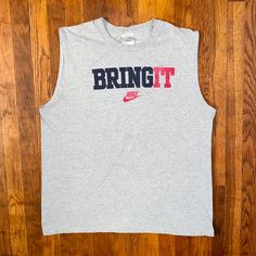 Dope tank top from the early '00s. Big spellout and logo on front. Has some faint staining on the "B" and "R" otherwise in good condition. Tagged an XL but fits more like a L.  Brand: Nike Size: L Color: Gray, Black, Red Condition: Good Cotton Tank Top With Logo Print, Casual Sleeveless T-shirt With Logo Print, Pre-shrunk Cotton Sleeveless T-shirt, Tank T-shirt With Letter Print For Streetwear, Cotton Letter Print Vest For Streetwear, Cotton Vest With Letter Print For Streetwear, Y2k Sleeveless T-shirt For Streetwear, Sleeveless Screen Print Tops For Streetwear, 90s Letter Print Tank Top For Streetwear