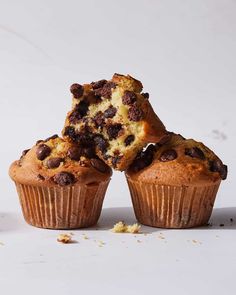 chocolate chip muffins stacked on top of each other with one cut in half