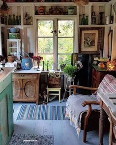 an old fashioned kitchen with lots of clutter