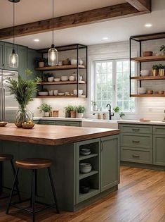 a kitchen filled with lots of green cabinets and counter top next to a wooden floor