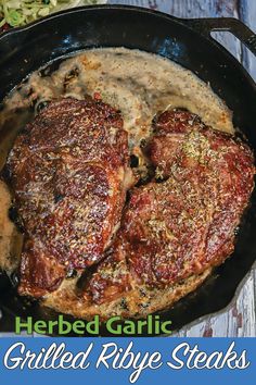 two steaks are cooking in a skillet with gravy on the side