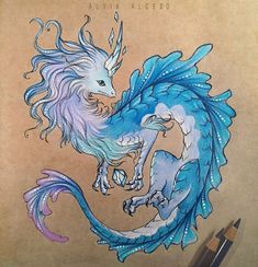 a drawing of a blue and white dragon next to a pencil on a piece of paper