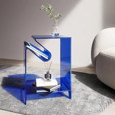 a blue glass table with a vase on top