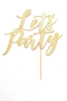 a cake topper that says let's party on it with gold glitters