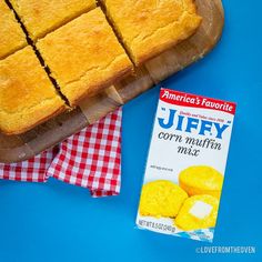 a box of puffy corn muffins next to a cutting board