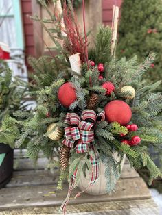 a potted plant with pine cones and ornaments