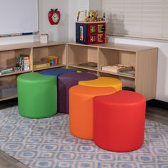 colorful stools and tables in a child's playroom with bookshelves