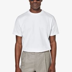 This white crewneck T-shirt boasts a "straight" fit that lends a modern aesthetic to your style. Sport it as a base layer or roll up the sleeves & keep it classic with jeans or shorts. Modern Crew Neck T-shirt For Summer, Modern Crew Neck Summer T-shirt, Modern White T-shirt For Everyday, Modern White Everyday T-shirt, Classic T-shirt With Straight Hem And Relaxed Fit, White Crew Neck Top With Minimal Stretch, White Relaxed Fit Modern T-shirt, White Classic Top With Straight Hem, Classic White Basic Style T-shirt