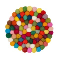 multicolored felt balls arranged in a circle on a white background, top view