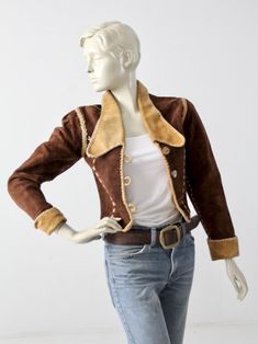 "This 1970s vintage, custom leather jacket has bold rock n' roll style. The rare find, was hand crafted and features whip-stitch and braid detailed seams. It fits cropped and fitted with slightly puffed shoulders. Dark brown suede shapes the jacket with yellow leather detailing on the big collar and rolled cuffs. Princess seams down the bust are detailed with cross-stitches. The jacket closes with 3 horn buttons, and opens to a fully lined interior. CONDITION In great condition with wear consist Western Style Fitted Leather Jacket For Winter, Fitted Western Leather Jacket For Winter, Vintage Outerwear With Contrast Stitching For Fall, Vintage Winter Outerwear With Contrast Stitching, Vintage Outerwear With Contrast Stitching For Winter, Fitted Leather Jacket With Contrast Stitching For Fall, Vintage Hand-stitched Outerwear For Fall, Fitted Leather Cropped Jacket For Winter, Fitted Leather Cropped Jacket For Fall