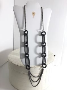 Gunmetal mesh chain vintage necklace is a punk statement piece. A collage of mixed sizes & textures, this adjustable length necklace adds an edgy vibe to any outfit, from a plain black or white tee to a fun print jumpsuit, as shown here. Gunmetal tone round links alternate with long oval lengths.  A triple chain in smaller scale but same tone is swagged at bottom center of necklace. No marks or stamps on this piece.  MEASUREMENTS  Length adjusts from 37 to 40" Individual round coiled links are 1 Vintage Versace, Vintage Swimsuits, Plain Black, Black Mesh, Fun Prints, Turquoise Earrings, Vintage Accessories, Vintage Necklace, Long Necklace