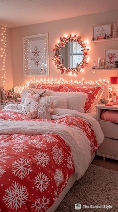 a bedroom decorated for christmas with lights on the headboard and red bedding,