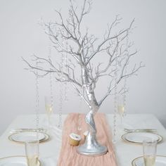 there is a silver tree on the table