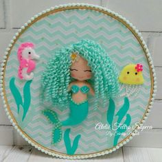 an image of a mermaid doll on a plate