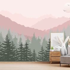 a living room with mountains and trees painted on it's walls, along with a couch