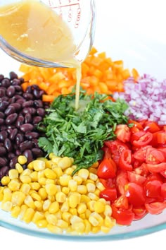 the ingredients for this salad are mixed together in a glass bowl with a measuring cup