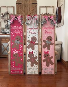 three wooden signs with gingerbread kisses and christmas wishes on them in front of a door