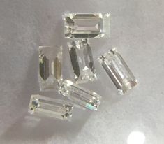 three different sized diamonds sitting on top of a white countertop next to each other