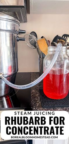 a glass jug filled with liquid sitting on top of a counter next to a stove