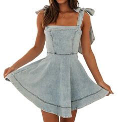 a woman wearing a denim dress