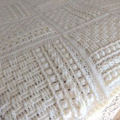 a crocheted blanket sitting on top of a wooden table