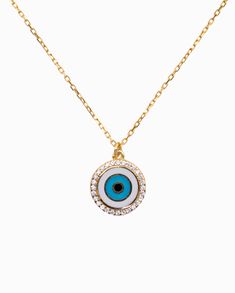 Sparkling round brilliant cut cubic zirconias frame this round medallion lucky evil eye pendant, giving it a touch of modernity as it wards off bad vibes. Rich enamel detail brings this talisman to life in chic style, perfect for adding color and cultural influence to your necklace layering looks. A secure clasp keeps our delicate cable chain Tara Necklace in place, connected to the pendant, keeping it centered. Designed in 925 sterling silver yellow gold plating. Metal Type: 925 Sterling Silver Evil Eye Charm Necklace With Round Pendant, White Evil Eye Round Pendant Necklace, White Round Pendant Necklace With Evil Eye, Bad Vibes, Necklace Layering, Eye Pendant, Evil Eye Pendant, Round Brilliant Cut, Cable Chain