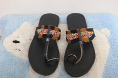 Unique Gift | Sandals | Gladiator Sandals | Greek Sandals | Beach Jewelry | Wedding Shoes | Leather Sandals | Custom | Mothers GiftAn elegant and authentic pair of African inspired beaded ladies sandals, with a unique and eye-catching design. 100% genuine leather. *100% genuine leather.Main Color - Multicolored. ✂⋯⋯ S I Z E  C H A R T ⋯⋯✂EU.........USA........UK.........CM............INCHES34..........3.5...........1.5.........22.3...........8.835..........4.5...........2.5........23............ Handmade Artisan Sandals With Round Toe, Traditional Adjustable T-strap Sandals With Single Toe Strap, Traditional Adjustable Toe Post Sandals, Handmade Adjustable Slip-on Sandals, Traditional Sandals With Adjustable Single Toe Strap, Traditional Round Toe Barefoot Sandals For Beach, Handmade Bohemian Open Toe Slippers, Bohemian Handmade Open Toe Slippers, Traditional Adjustable Slip-on Sandals