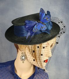 Elegant women's hat in black parasisal with veil, with abaca silk and butterfly in blue. This beautiful summer accessory is the perfect addition to any special occasion. High-quality parasisal material designed with fine parasisal fibres, this hat offers a soft and durable texture, ensuring comfort and style with every wear. The elegant and delicate veil adds an elegant touch. This hat is ideal for formal events, weddings and any occasion where you want to stand out with a unique and sophisticat Black Summer Wedding Headpieces, Black Summer Hat For Wedding, Black Summer Wedding Hat, Summer Black Wedding Hat, Summer Wedding Black Hat, Black Summer Top Hat For Church, Black Top Hat For Summer Church Events, Black Top Hat For Church In Summer, Black Mini Hats For Summer Weddings