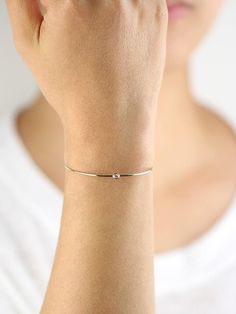 JSVConcepts Fine Jewelry Diamond Bangle Bracelet, Diamond Solitaire Bangle Bracelet, Minimalist Bracelet, 14K Gold Bangle Bracelet, Diamond Bracelet, Gift for her ≫ Product Details ◈ Handmade / Handcrafted Fine Jewelry ◈ Diamond: 100% Natural Diamond ◈ Diamond Weight: 0.07 ct. (2.60 mm) ◈ Color: G Color ◈ Clarity: VS-SI ◈ Cut: Brilliant Cut ◈ Bangle Thickness: 1.30 mm ◈ Metal: Solid 14K Gold (18K also available - Additional fees may apply) ◈ Gold Color: White gold, Rose gold, Yellow gold ≫ Pleas Minimalist Stackable White Gold Diamond Bracelet, Minimalist White Gold Stackable Diamond Bracelet, Minimalist Rose Gold Sterling Silver Bracelet, Minimalist Stackable White Gold Bracelets, Minimalist White Gold Stackable Bracelets, Minimalist Stackable Chain Bracelet For Formal Occasions, Minimalist Stackable Chain Bracelet For Formal Events, Minimalist White Gold Jubilee Bangle, Minimalist Diamond Bracelet For Formal Occasions