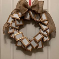 a wreath is hanging on the front door with a burluck bow around it